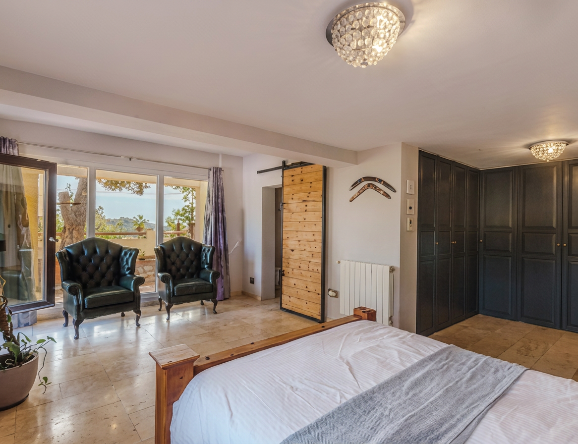 Master suite with seating area and custom wardrobes